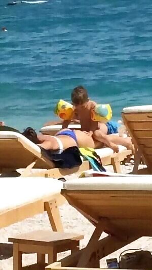 Kid humping his mom on the beach